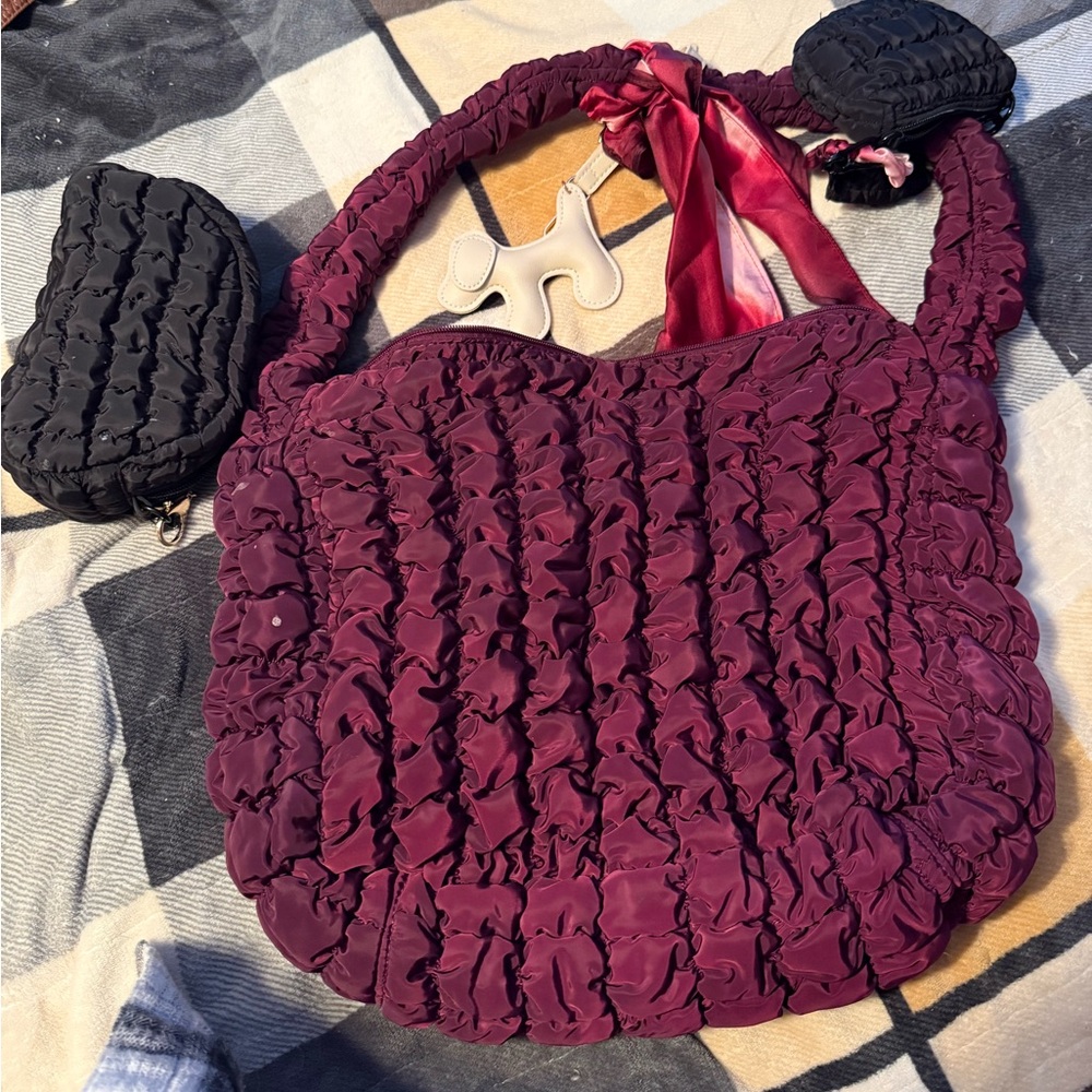 Burgundy puff hobo bag. Includes two smaller black bags. And two bag clips.